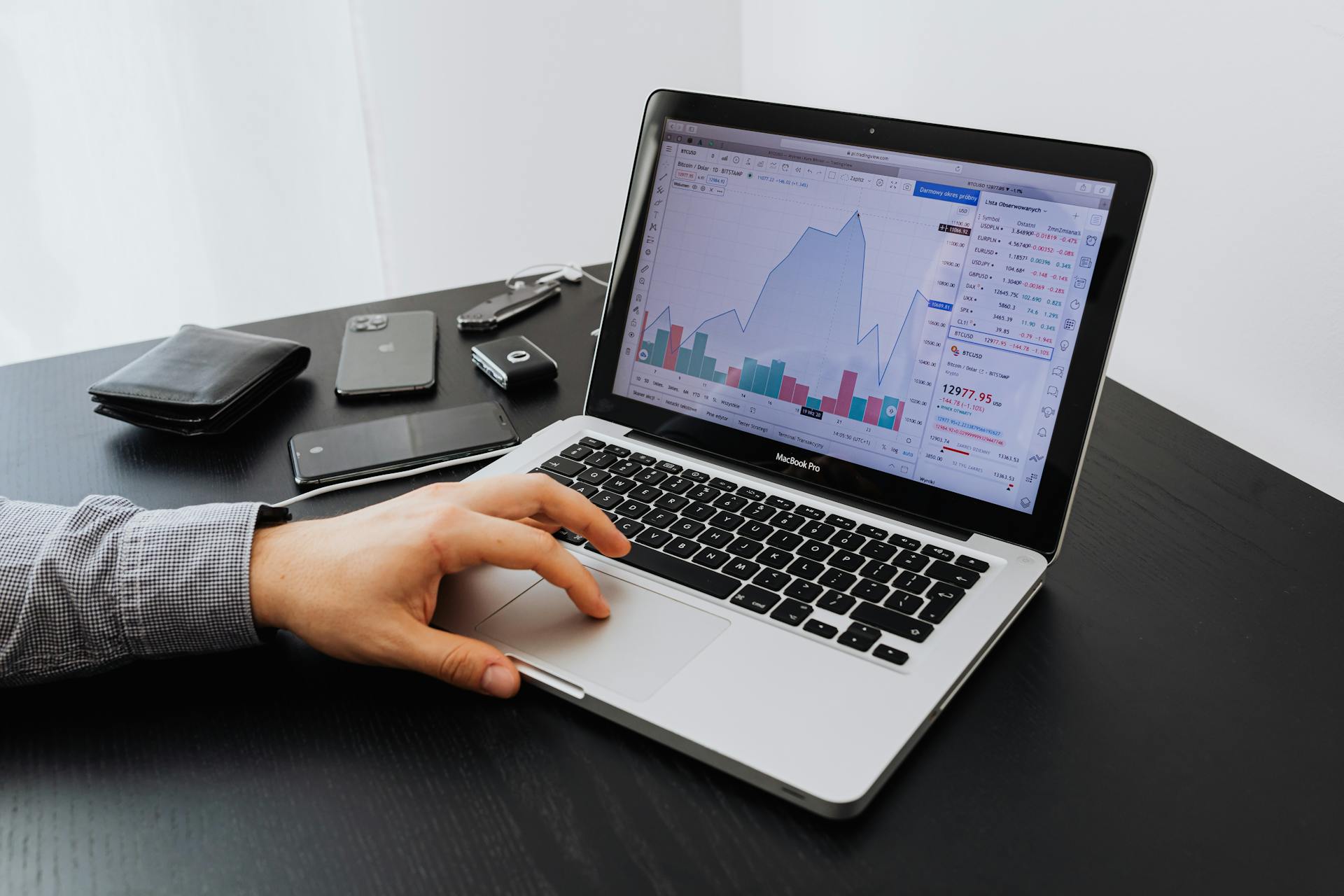 IT professional analyzing SaaS performance metrics on a laptop, demonstrating real-world application of monitoring tools